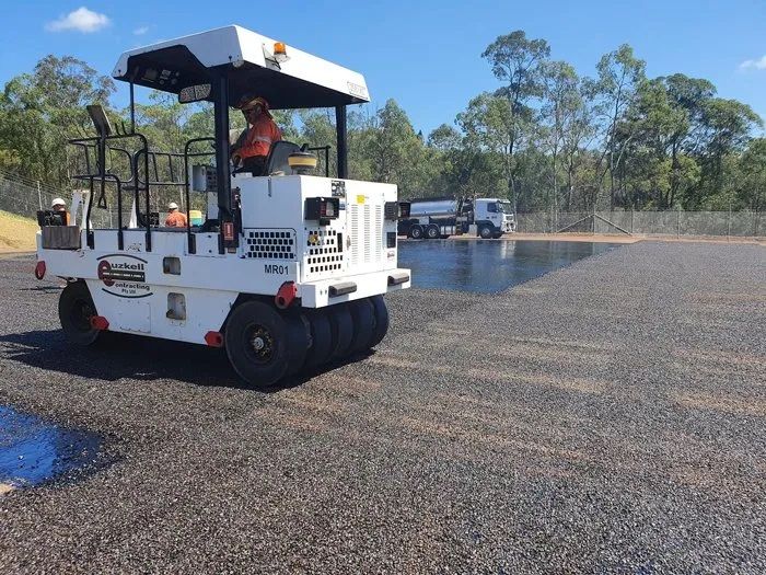 A Man is Driving a Roller on a Gravel Road — Cuzkell Pty. Ltd in Cooroy, QLD