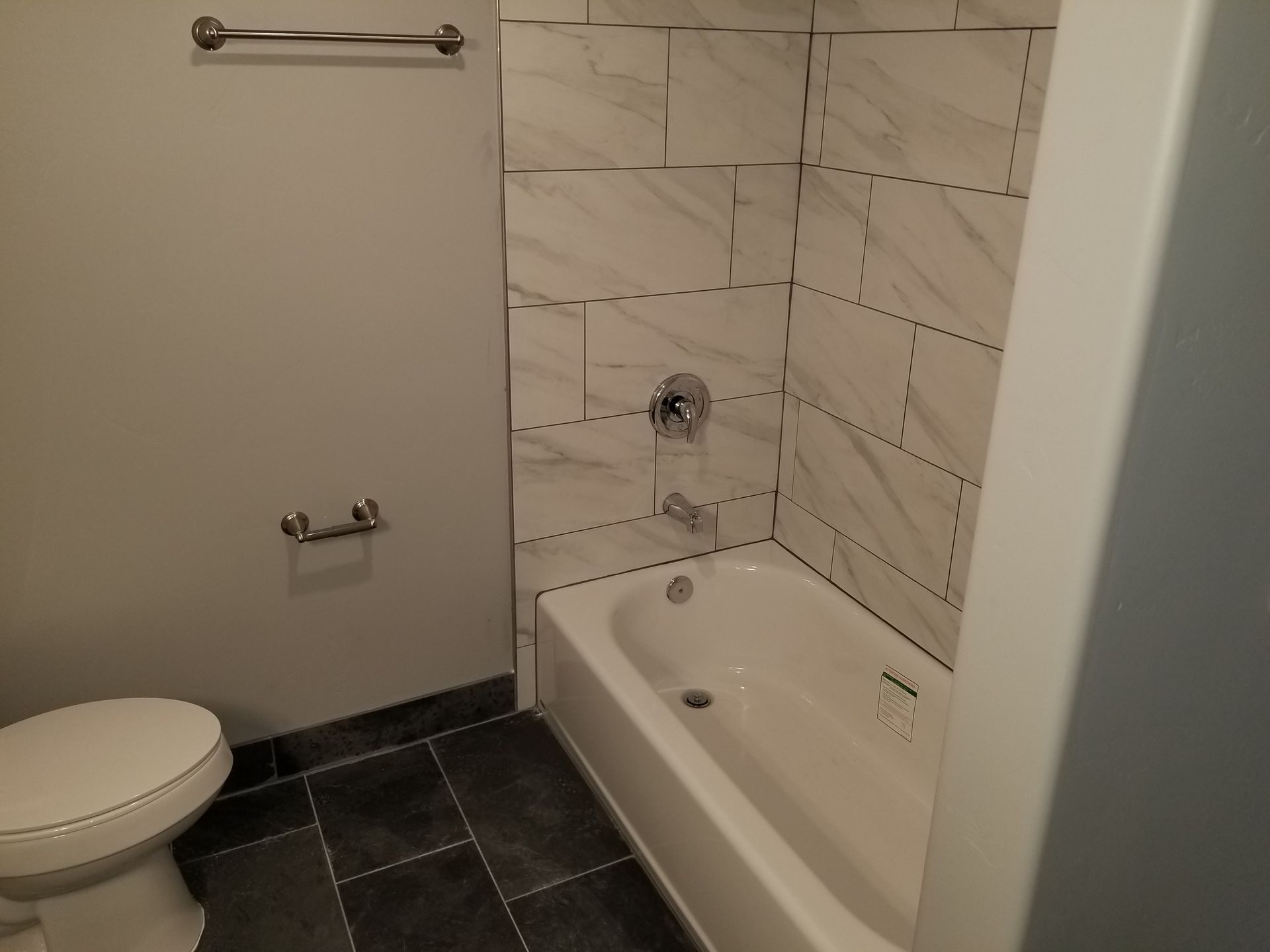A bathroom with a toilet and a bathtub