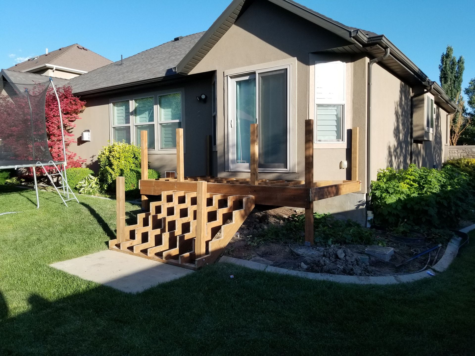 A small house with a wooden deck in front of it