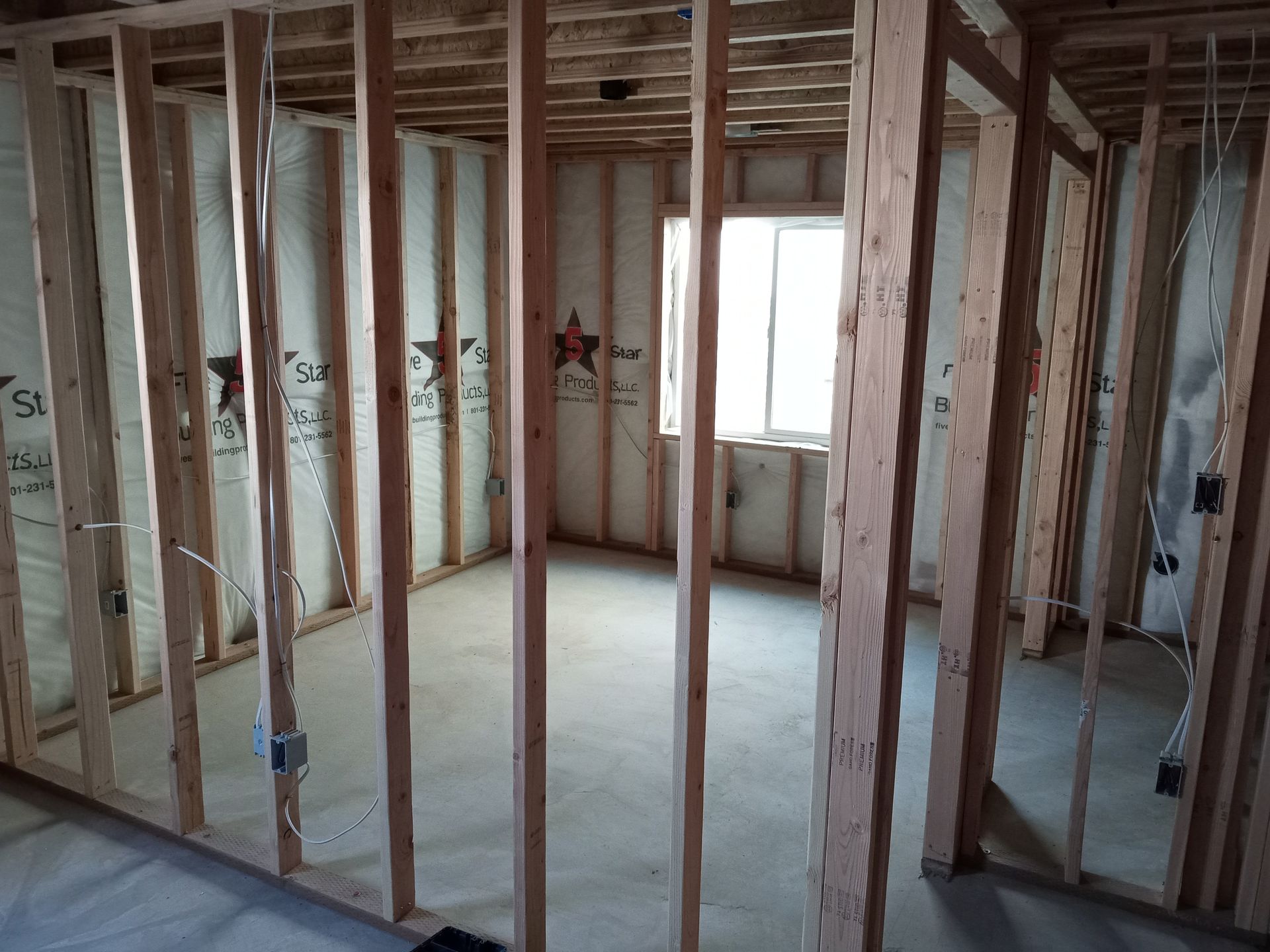 A room with a lot of wooden beams and a window.