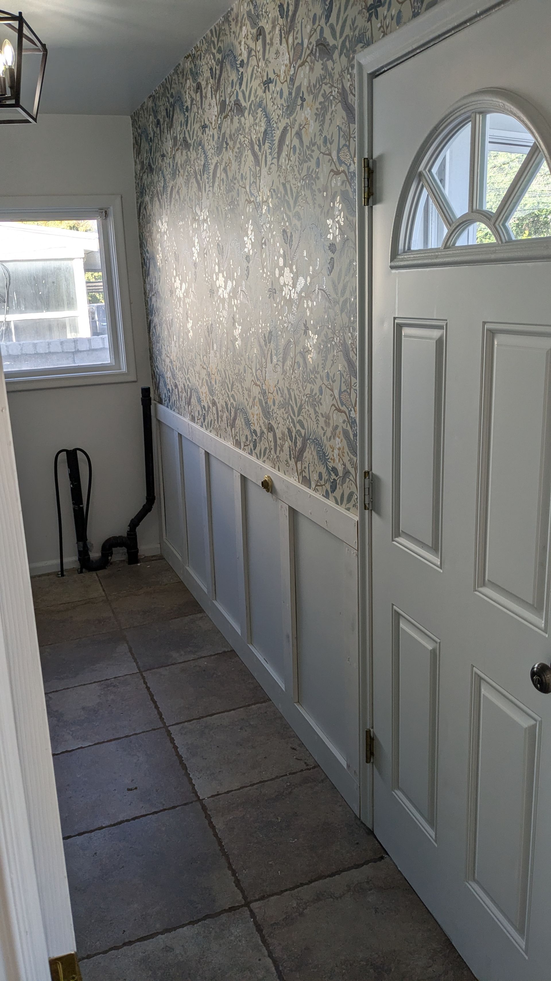 A hallway with a door and a window in a house.