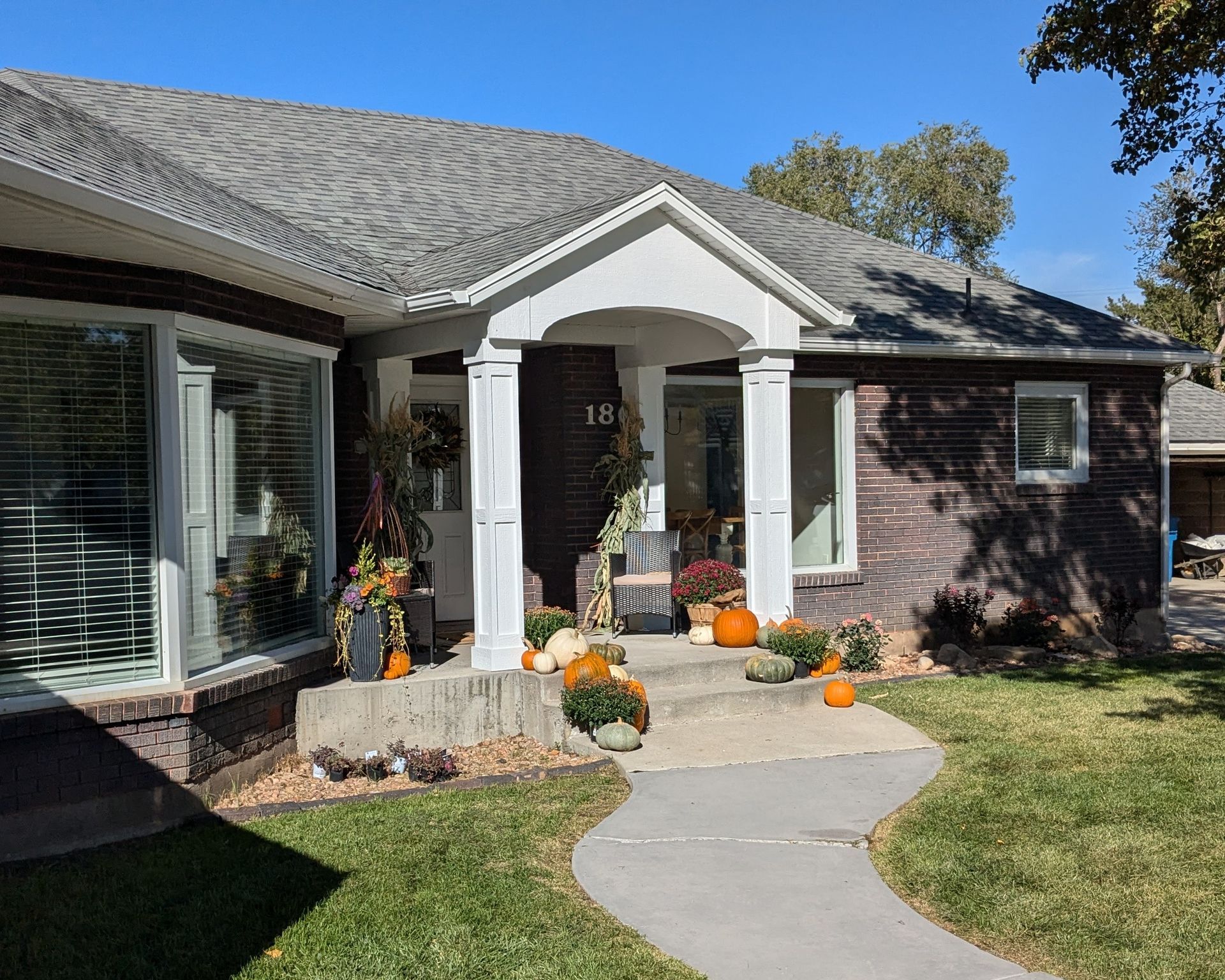 A brick house with the number 180 on the front door
