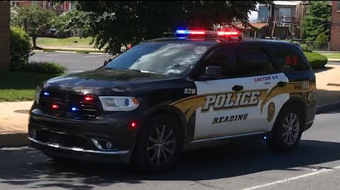 A police car is parked on the side of the road.