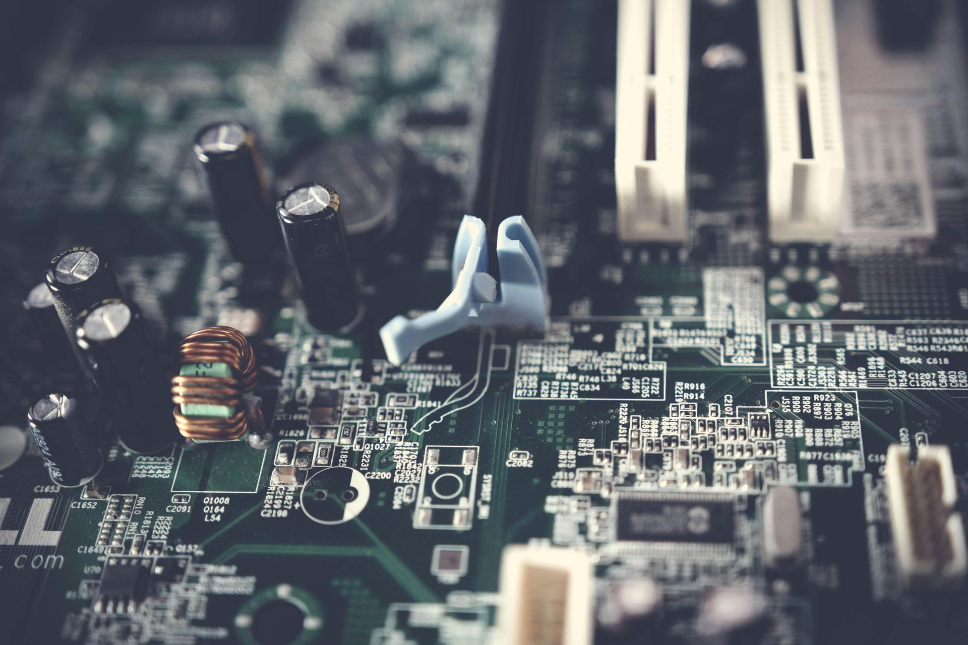 A close up of a computer motherboard with a lot of electronic components on it.