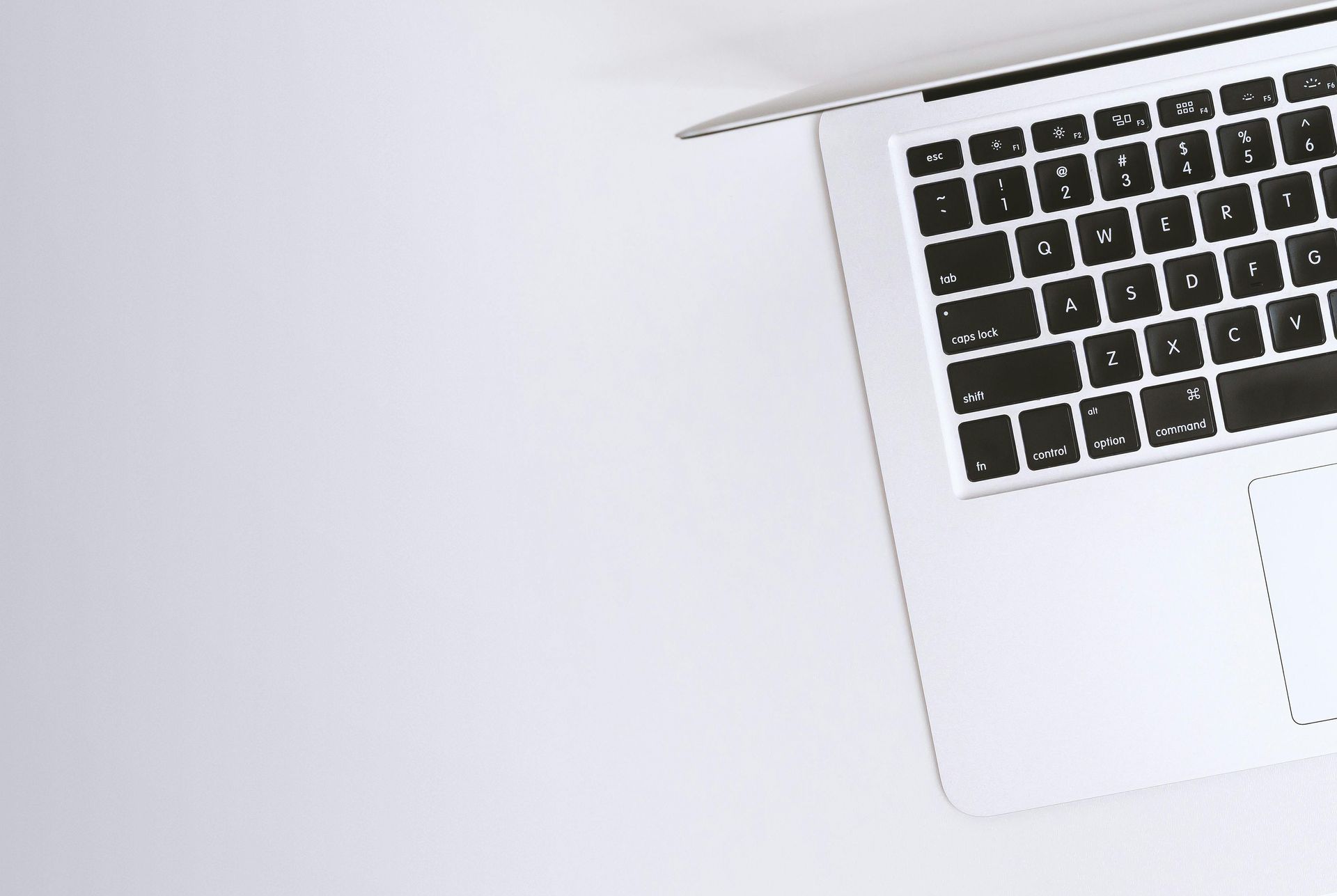 A laptop computer is sitting on a white table.