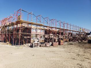 A large building is being built with scaffolding around it.