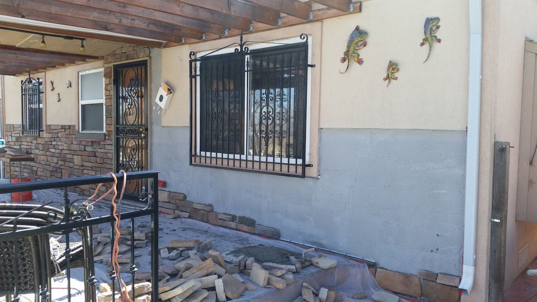A house with a fence and a few windows