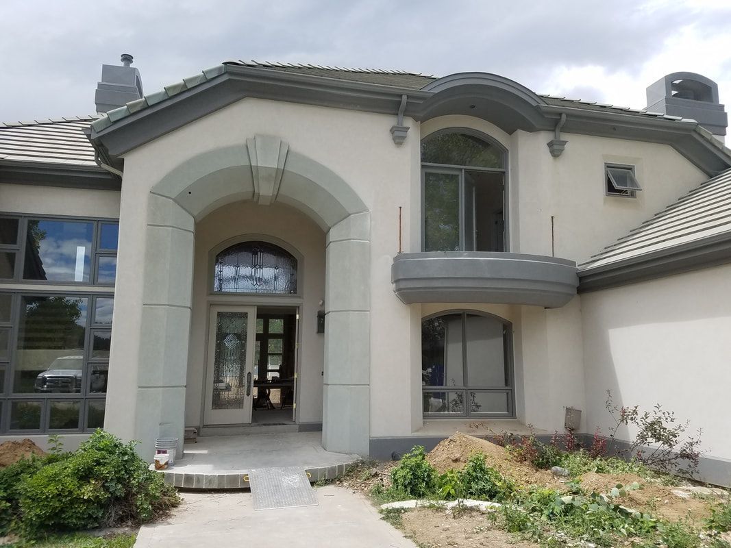 A large white house with a gray roof