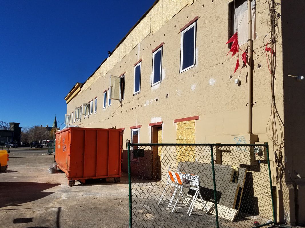 A large building with a chain link fence in front of it.