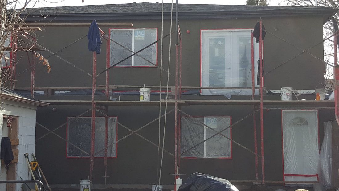A house is being remodeled with scaffolding around it.