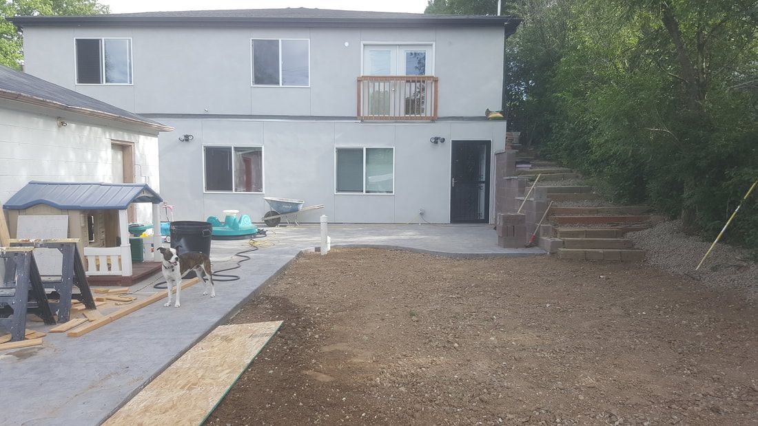 A large house with a lot of dirt in front of it.