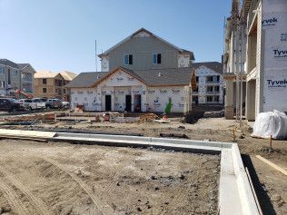 A house is being built in the middle of a construction site.