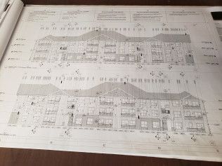 A black and white drawing of a building on a table.