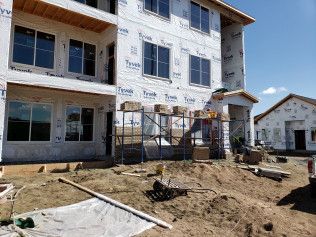 A building under construction with a lot of windows and scaffolding.