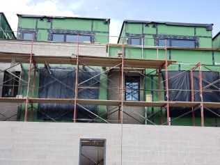 A building under construction with scaffolding on the side of it.