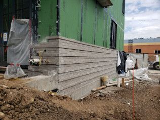 A concrete wall is being built on the side of a building.