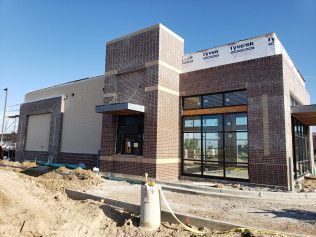 A large brick building with a lot of windows is being built.