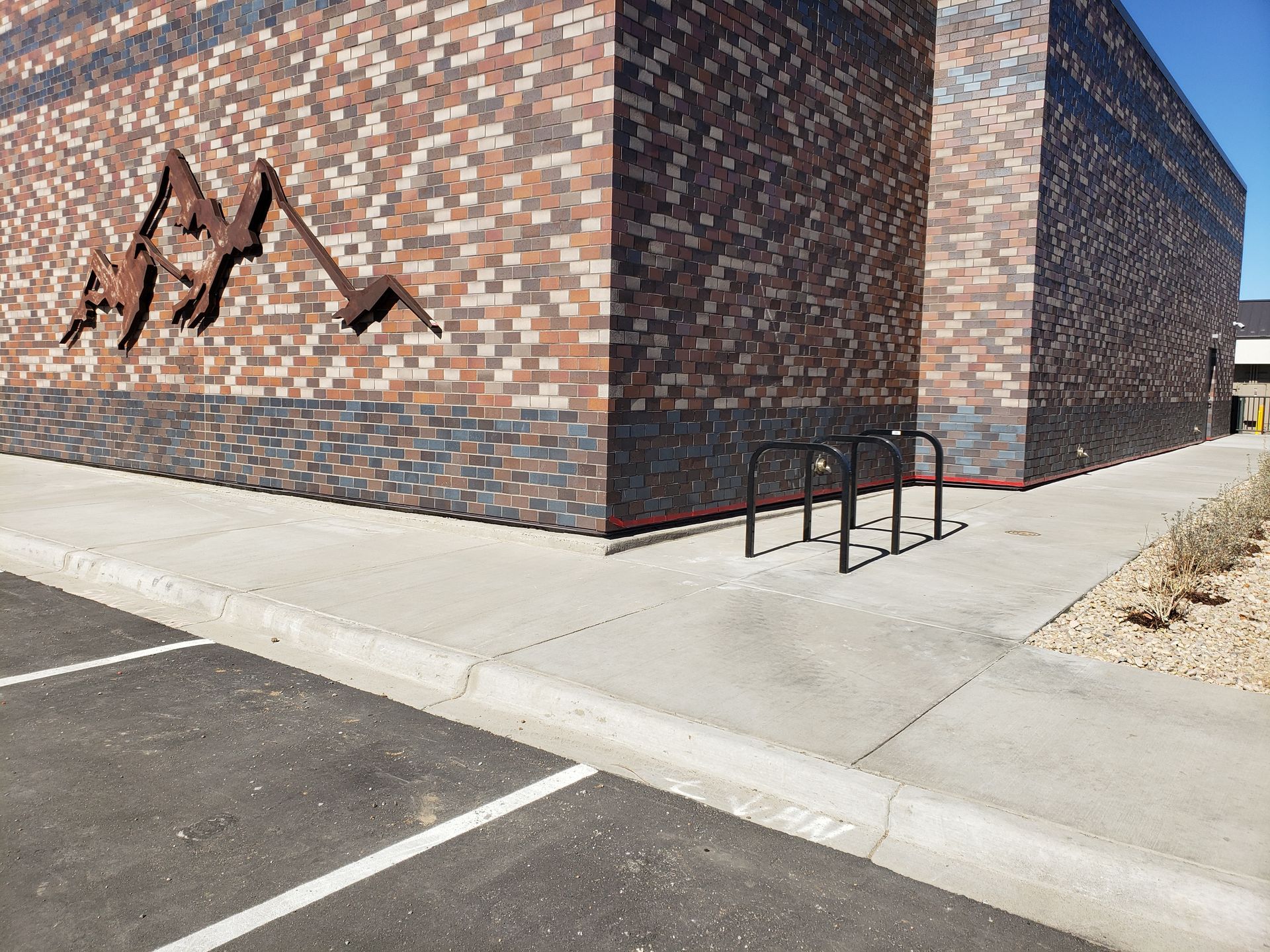 A large brick building with a bike rack on the side of it.