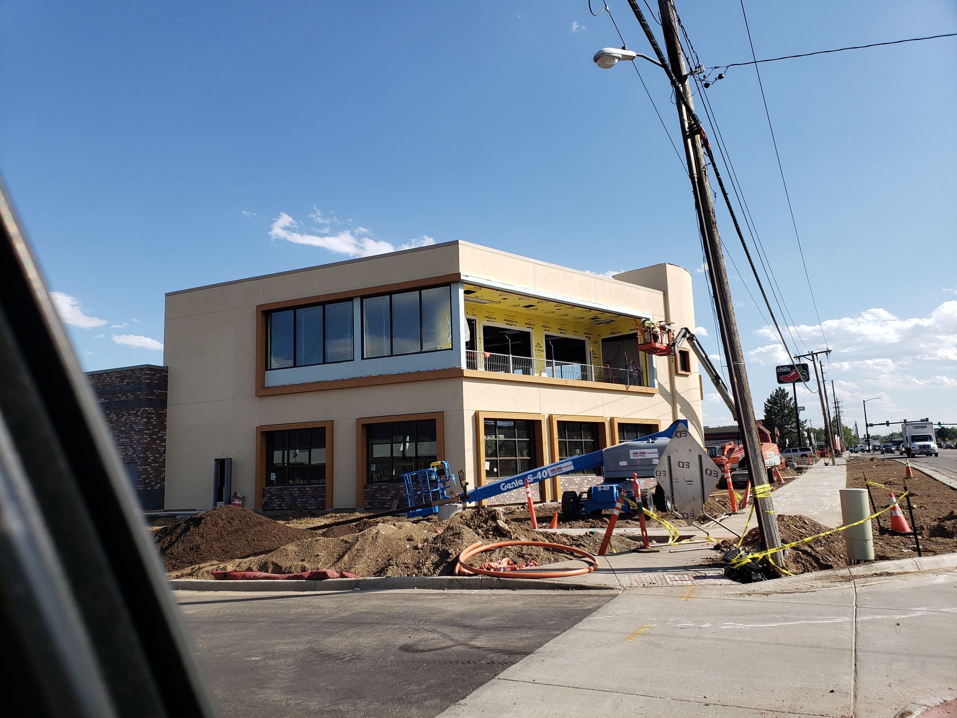A large building is being built on the side of the road