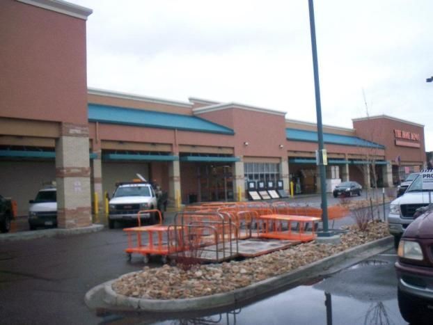 A home depot store with cars parked in front of it