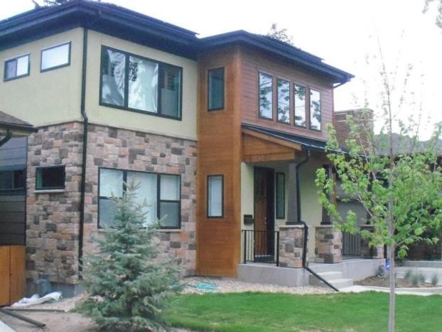 A house with a lot of windows and trees in front of it