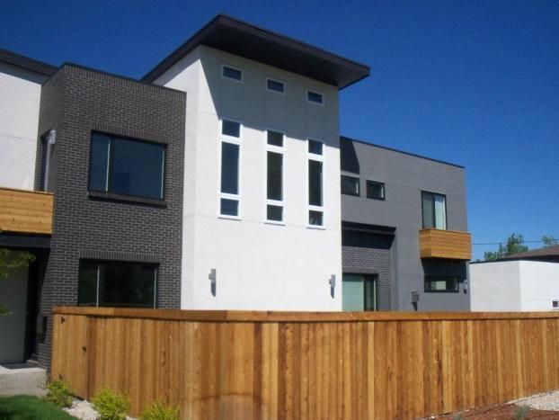 A house with a wooden fence in front of it
