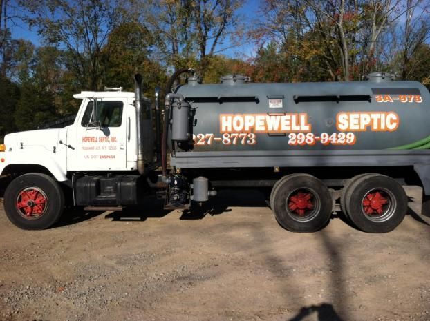 White and gray Hopewell Septic truck parked on gravel.