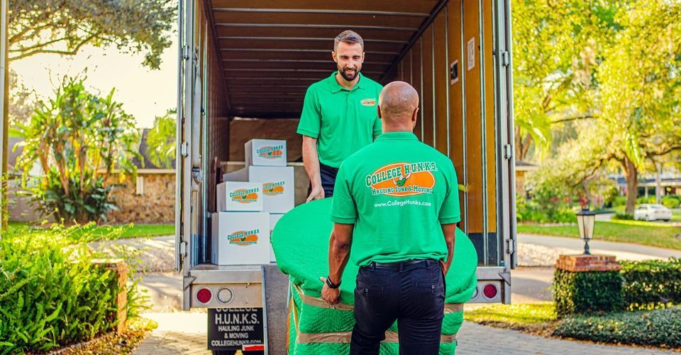 Men hauling boxes into a moving truck