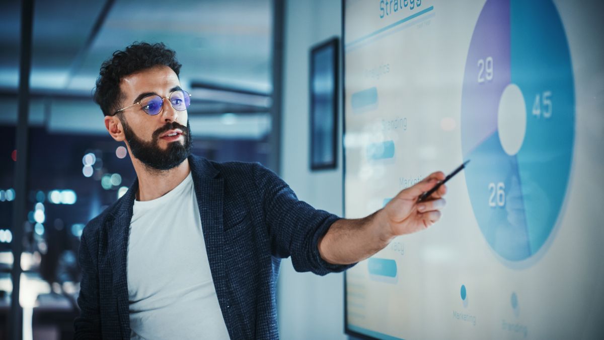 man pointing at a pie chart