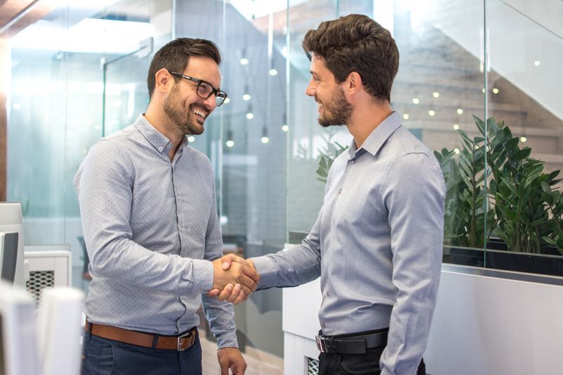 Two men shaking hands in an office