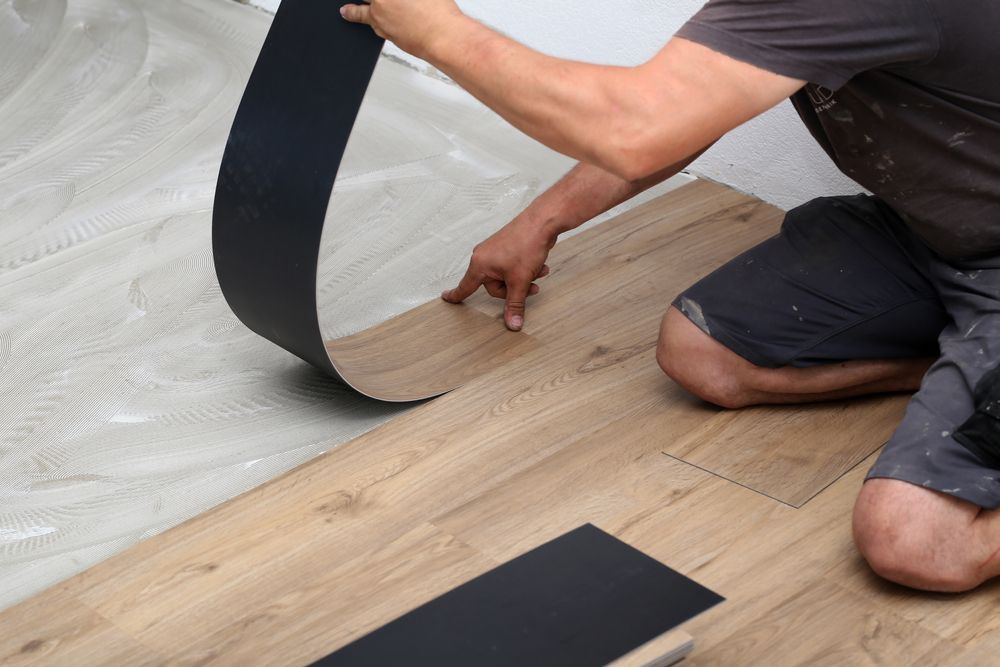 A Man Installing a Vinyl Floor — Taggerts Discount Carpets & Vinyls In California Gully, VIC