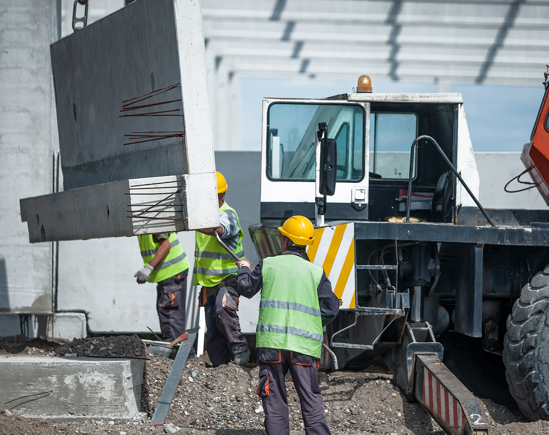 A group of construction workers are working on a construction site.