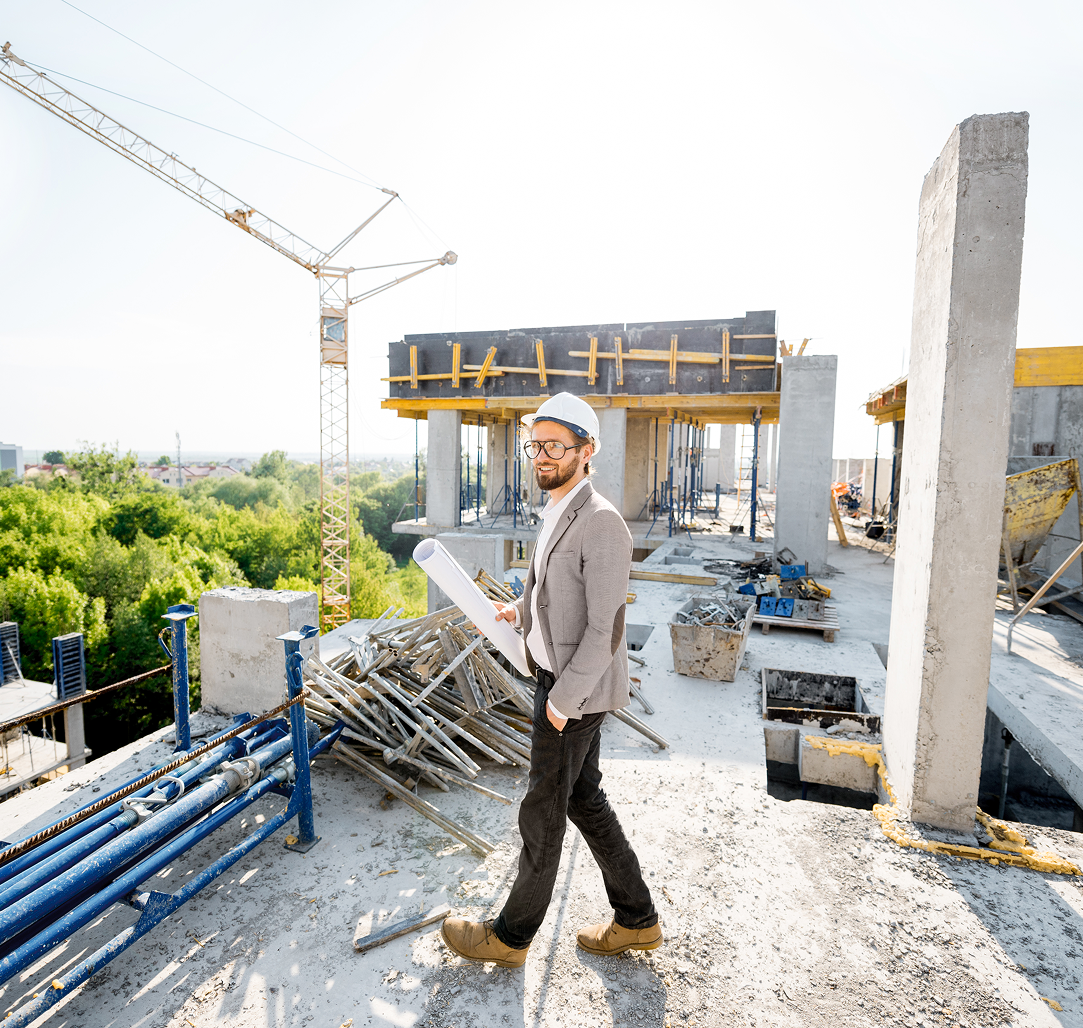 A man is walking on top of a building under construction.