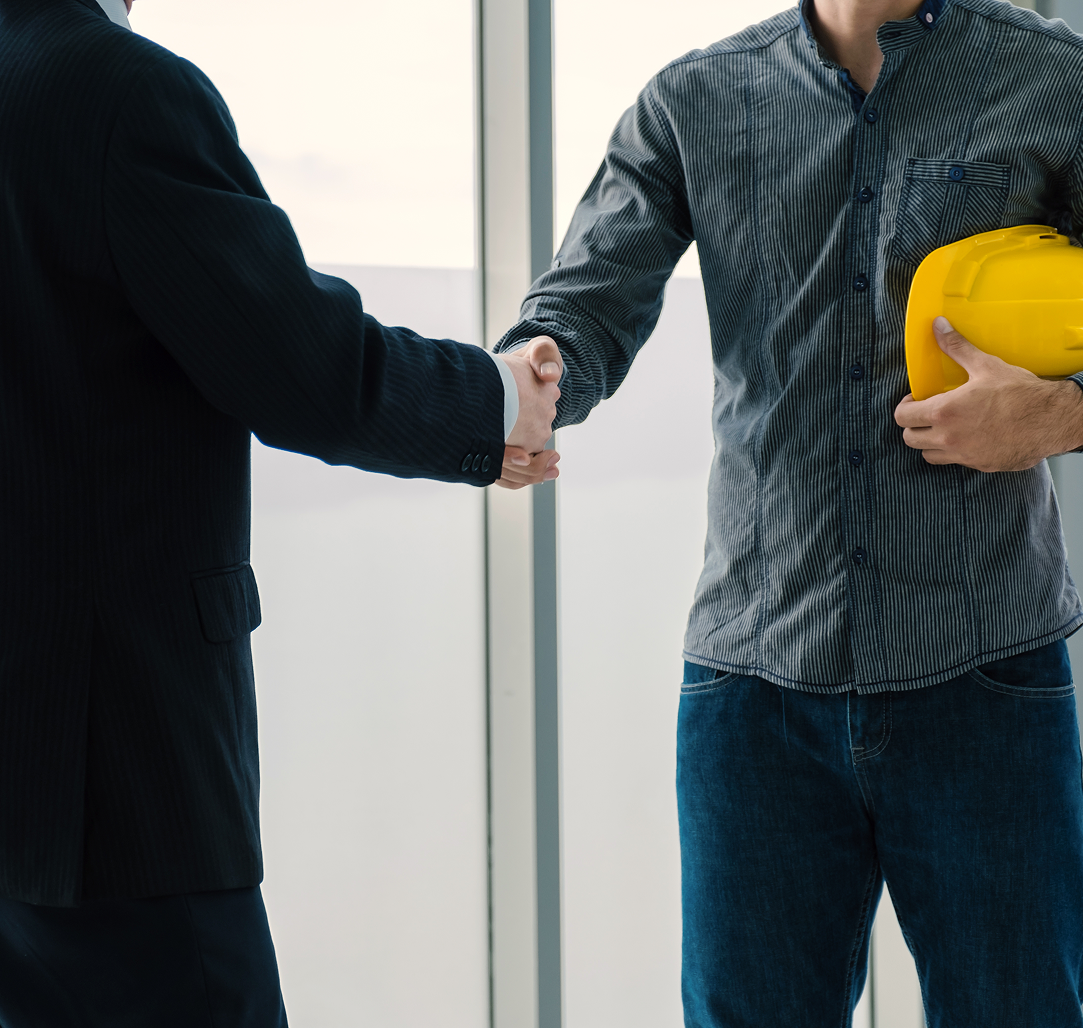 A group of construction workers are giving each other a high five.