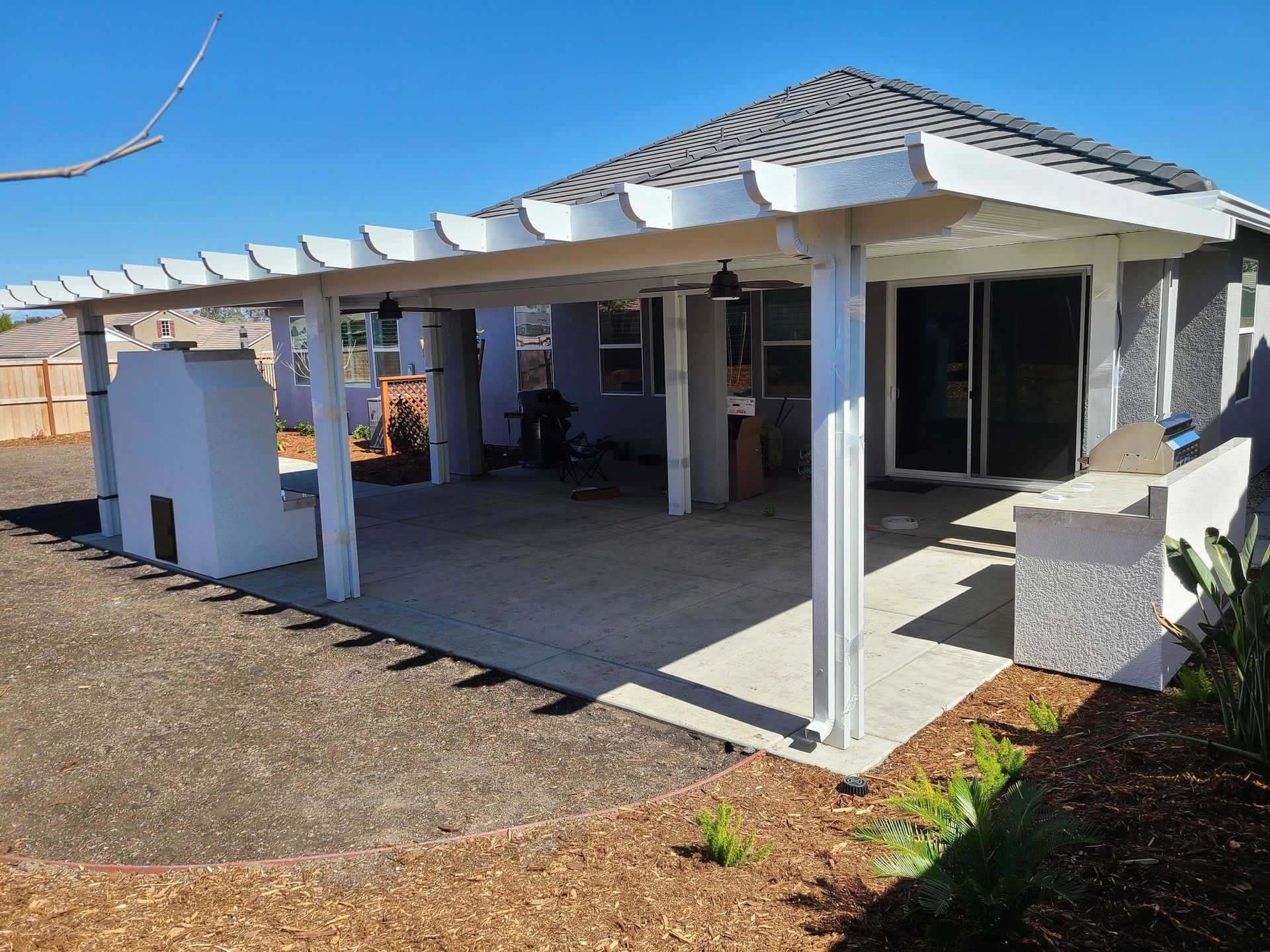 A house with a covered patio and a white pergola