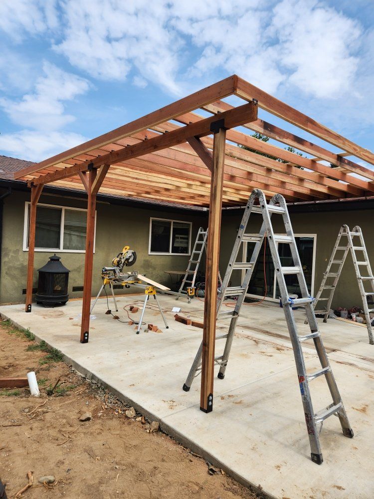 A wooden structure is being built on the side of a house.