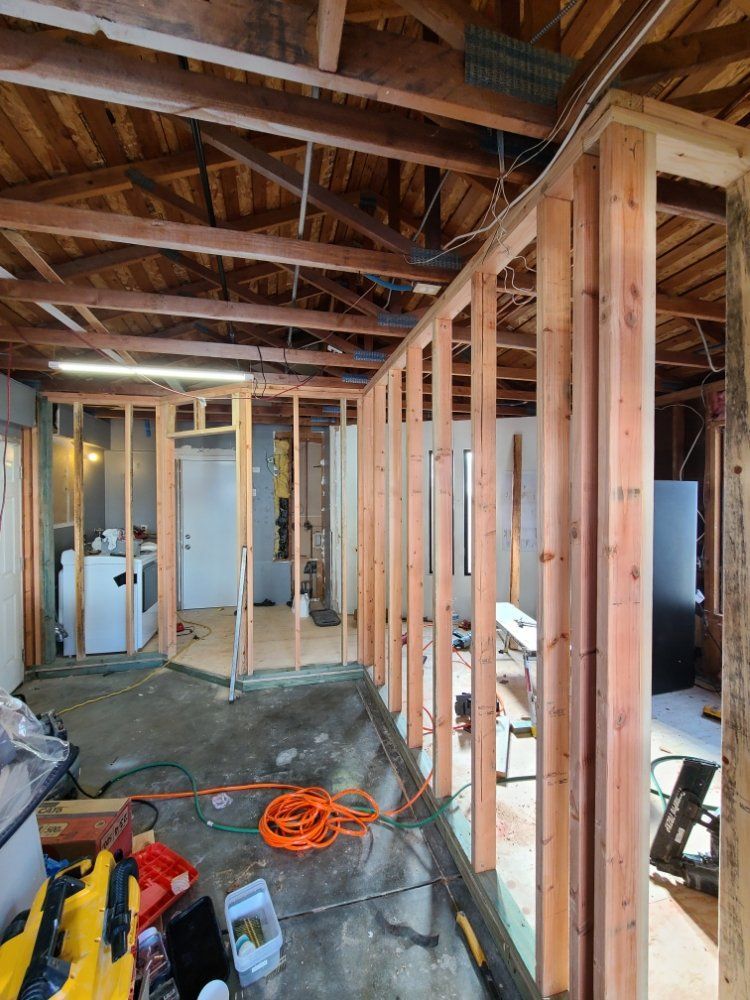 A room with a lot of wooden beams is being remodeled.