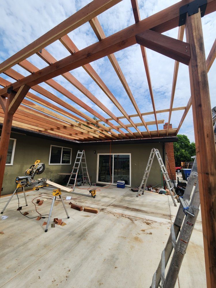 A wooden structure is being built on the side of a house.