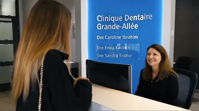A woman is talking to another woman at a dental office.