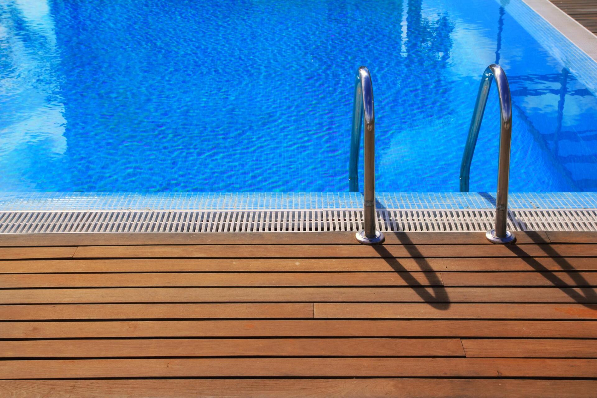 a swimming pool with wood deck