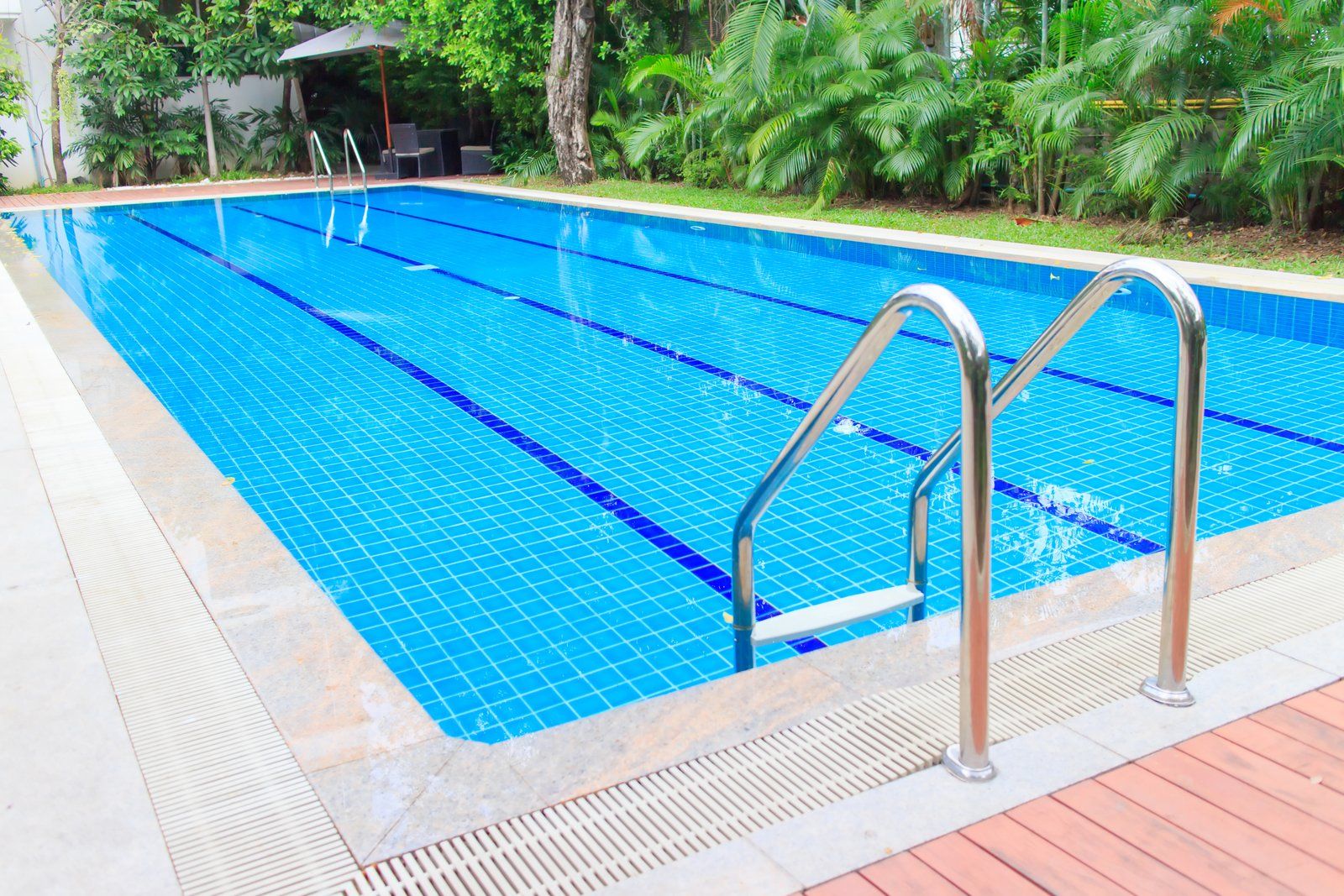 a swimming pool with stainless steel handrail
