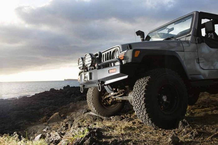 Low Angle View Of 4x4 On A Rocky Beach — Opposite Lock Wollongong in Oak Flats, NSW