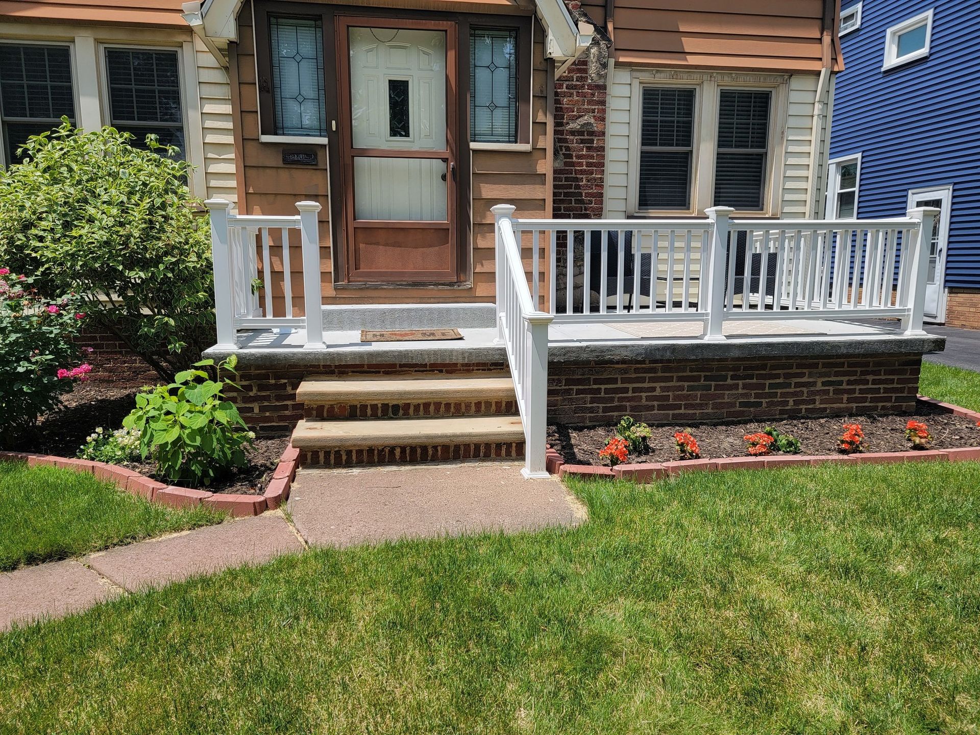The back of a house with a wooden deck and stairs