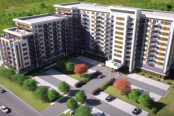 Une vue aérienne d'un grand immeuble d'appartements avec des voitures garées devant.