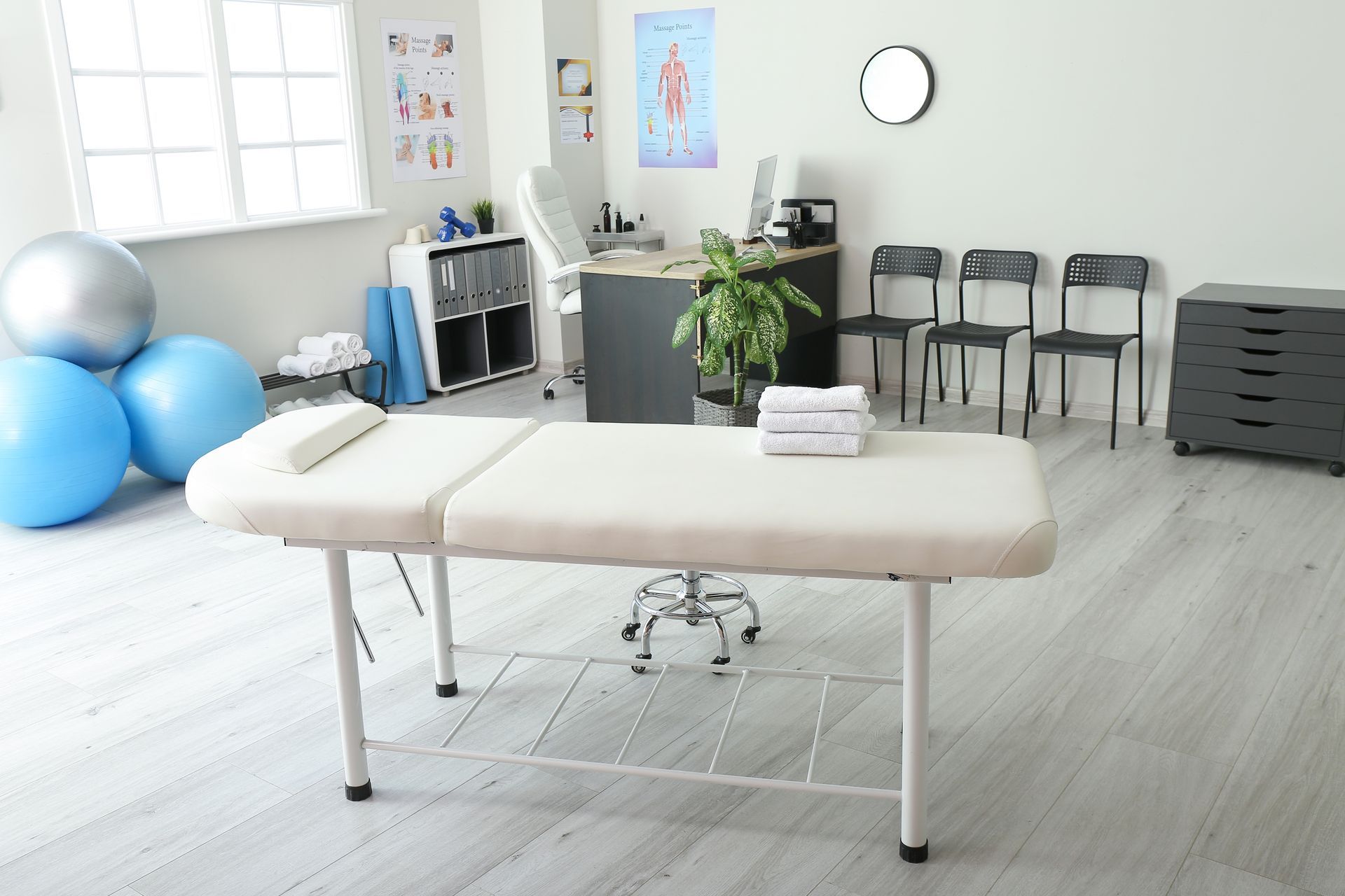 There is a massage table in the middle of the room.