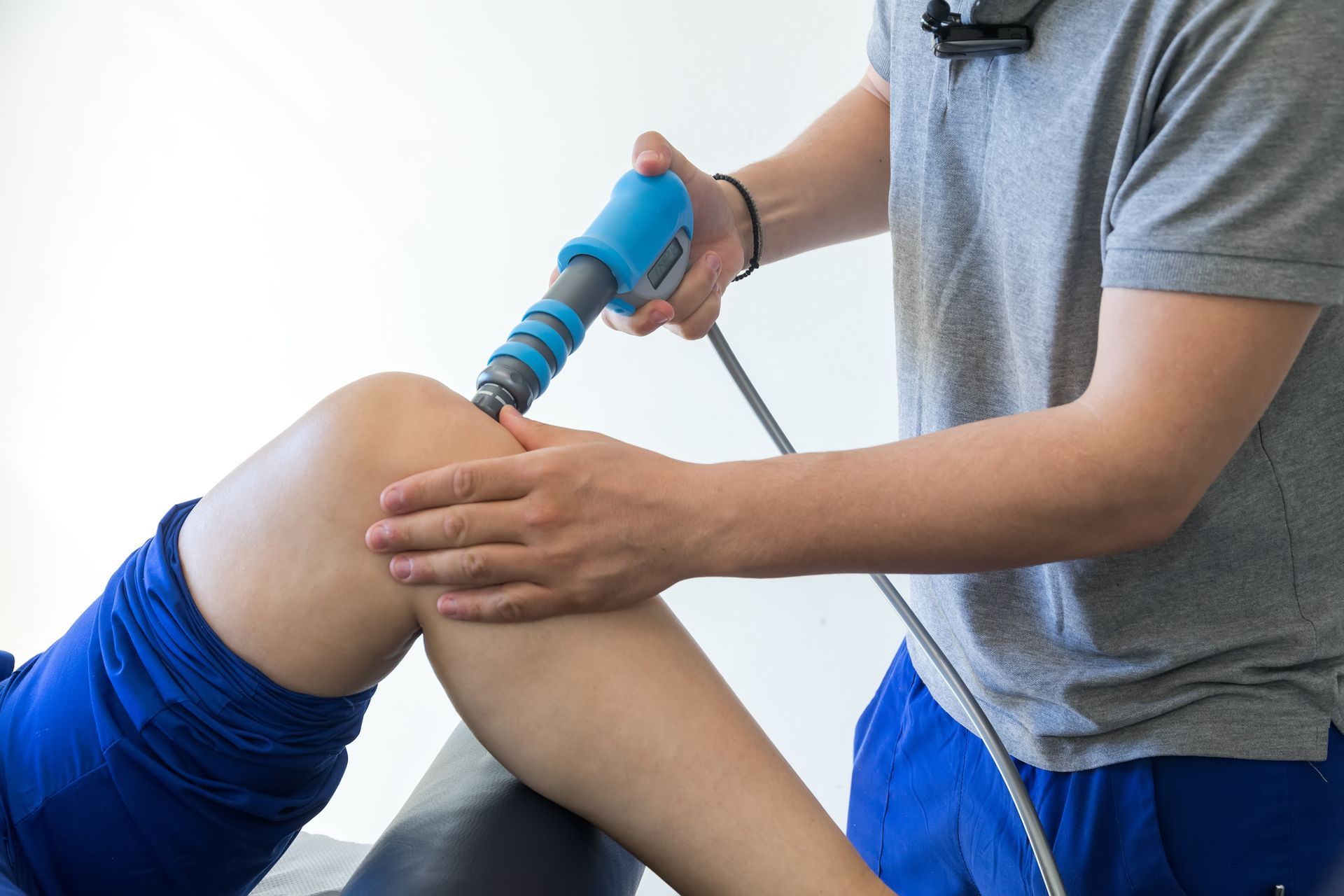 A person is getting a treatment on their knee with a machine.