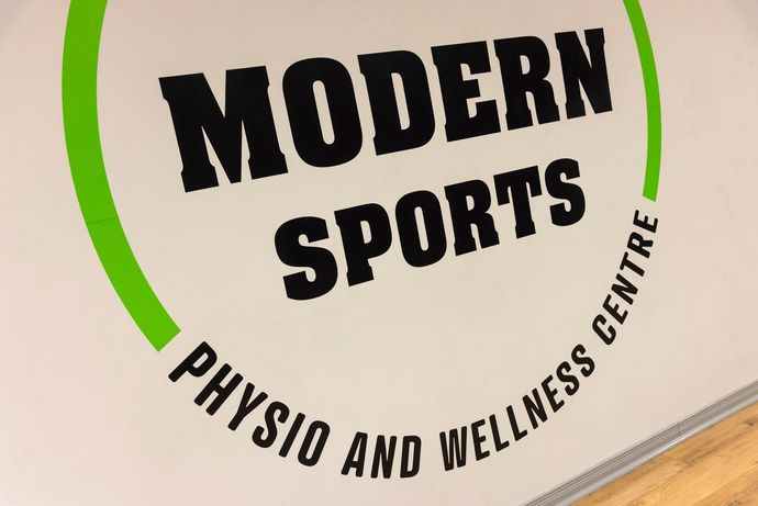 Modern Sports Physio & Wellness logo on wall inside their office
