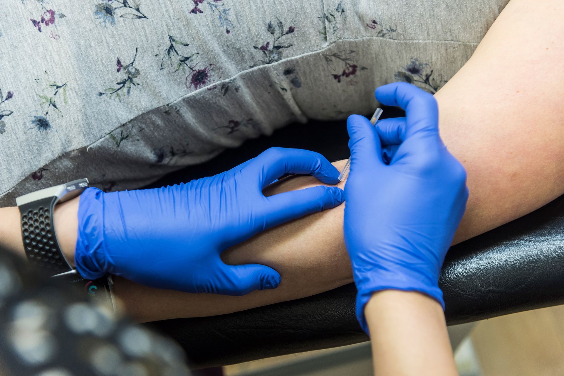 A person is getting an injection in their arm.