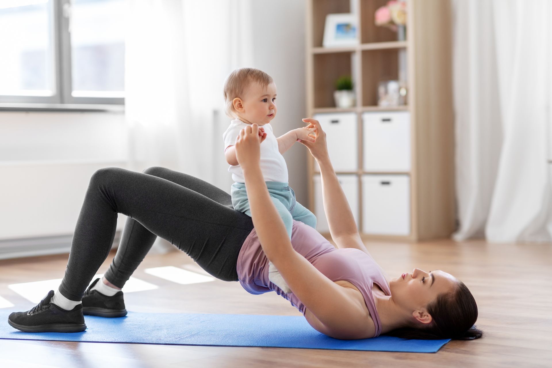 happy mother with baby doing pelvic floor physio exercises