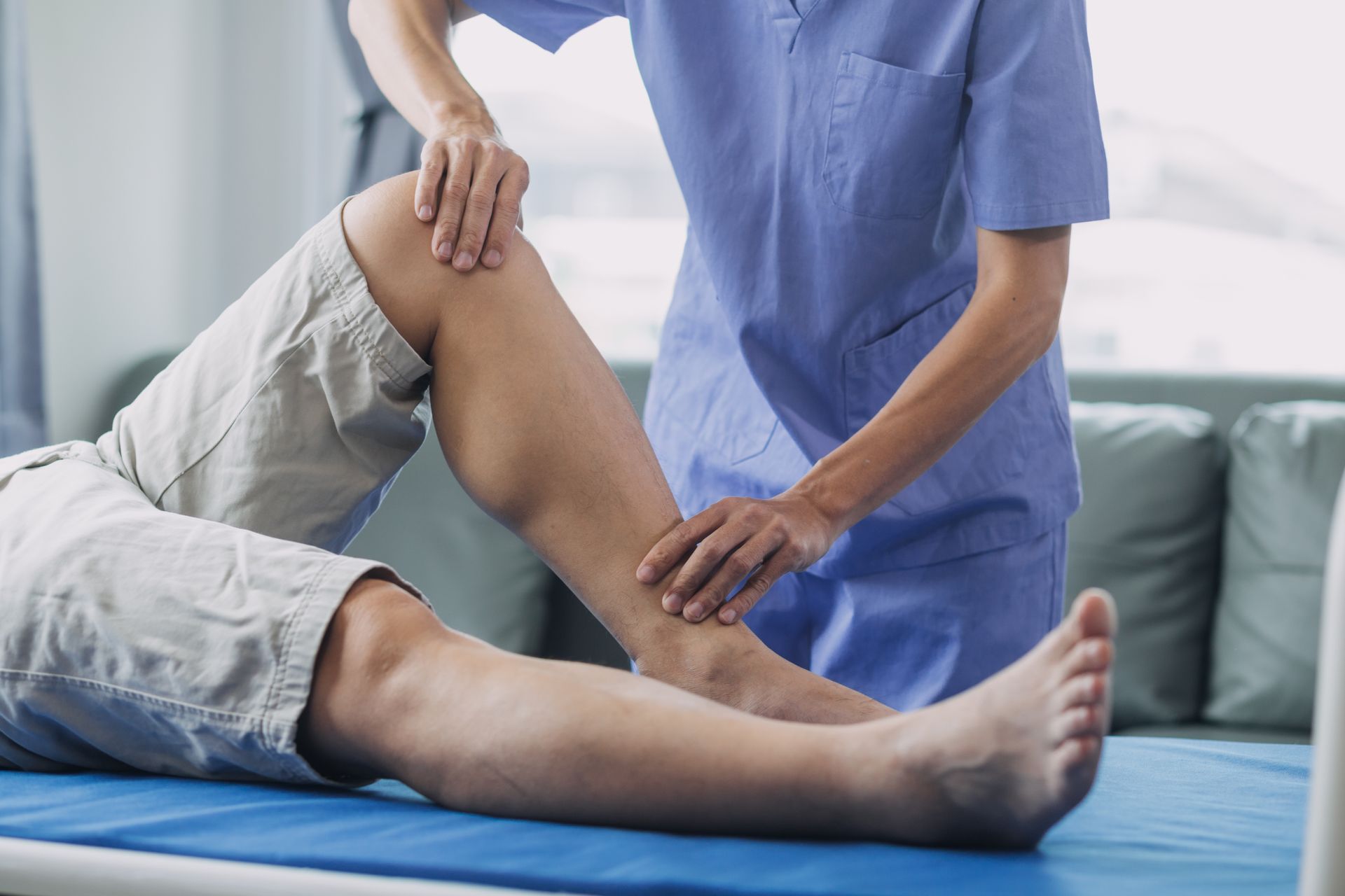 physiotherapist treating patient with orthopedic injury